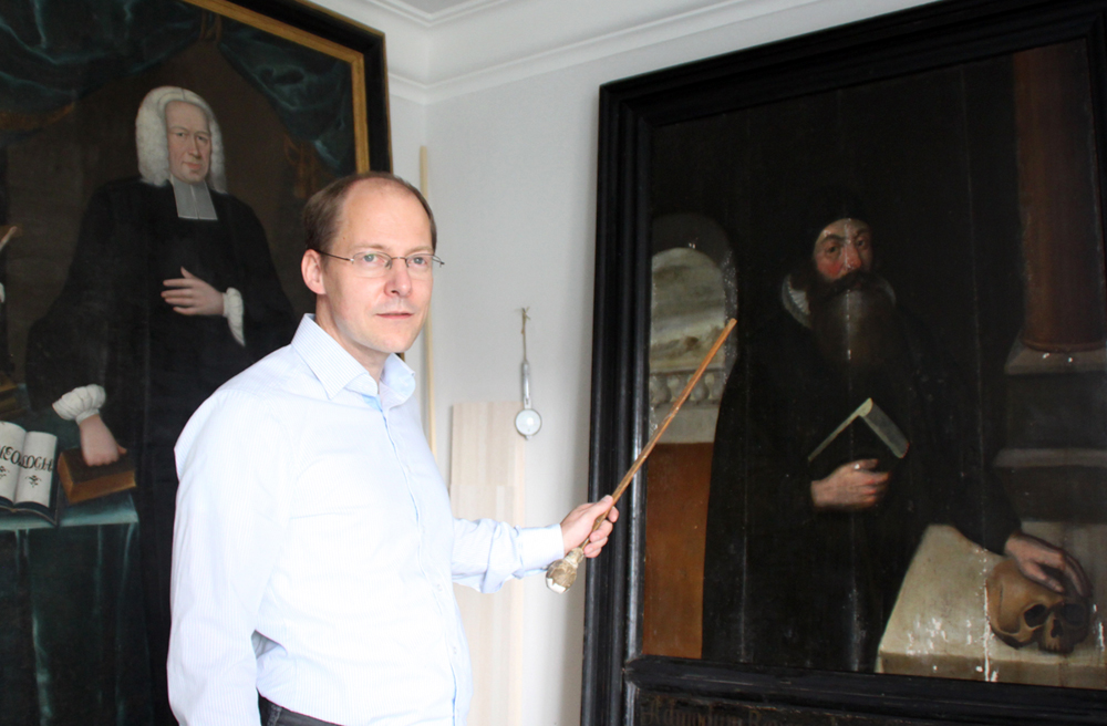 Restaurator Georg von Knorre vor zwei der Gemälde, eine Woche vor ihrer Fertigstellung