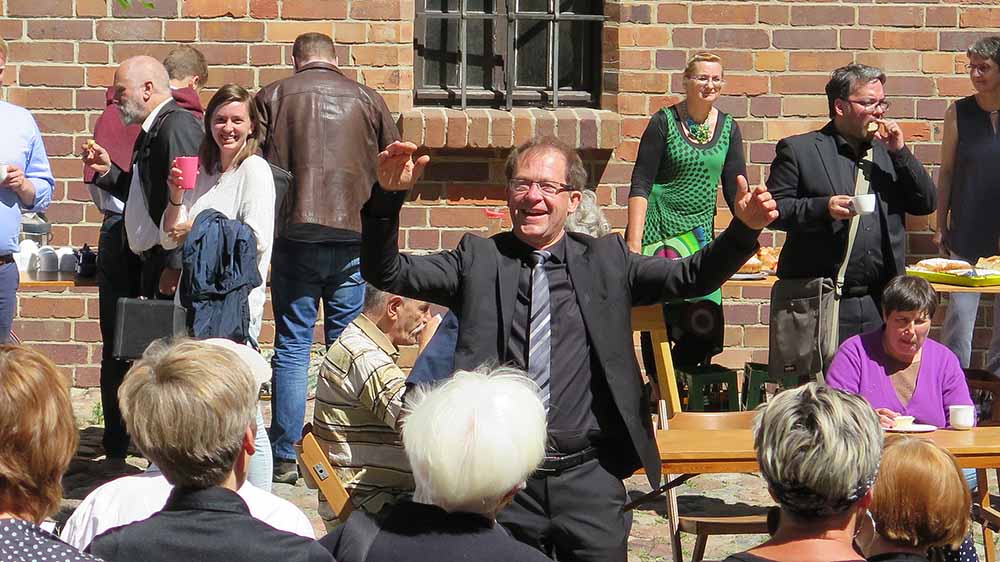 Frank Dittmer dirigiert zum Abschluss der Bach-Woche 2019 vor dem Greifswalder Dom St. Nikolai