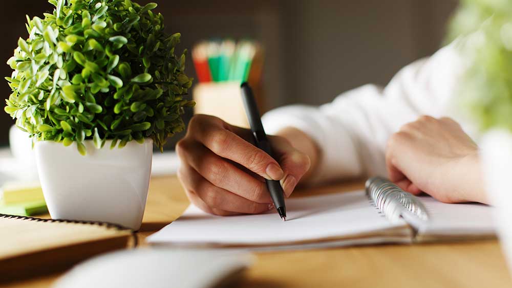 Nahaufnahme einer Hand, die einen Brief schreibt