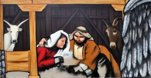 Graffiti-Darstellung der Krippenszene mit Ochs, Maria, Josef und dem Esel