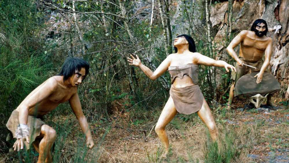 Eine Darstellung von Steinzeitmenschen im Parc de Prehistoire in der Bretagne (Frankreich)