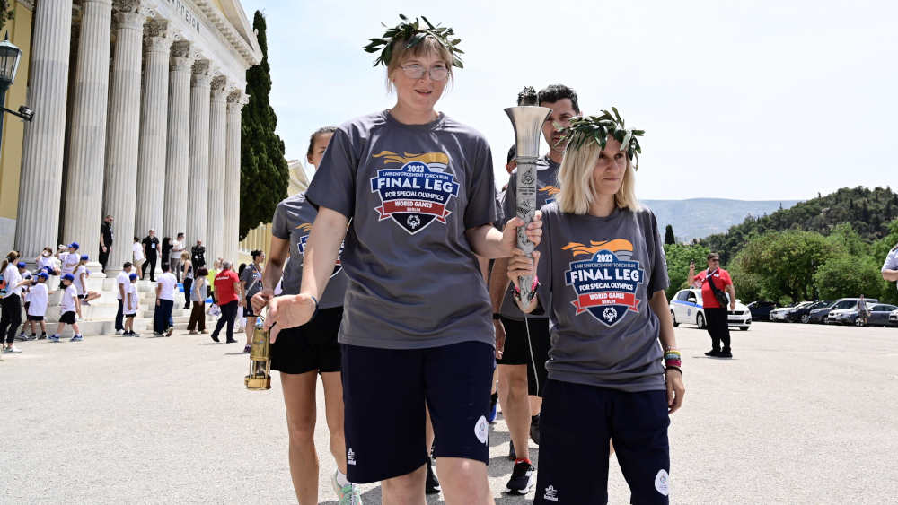 Mitglieder der deutschen Delegation für die Special Olympics World Games tragen die Flamme der Spiele in der Zappeion-Ausstellungshalle in Athen.