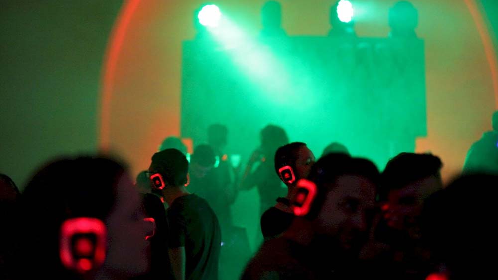 Jugendliche tanzen mit Kopfhörern auf einer Silent-Party