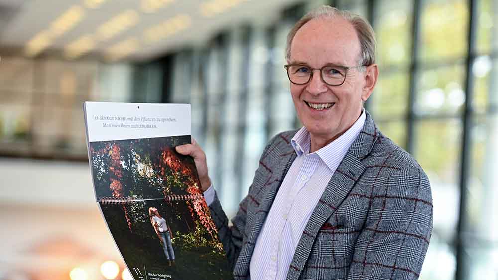 Landesbischof Ralf Meister zeigt ein Blatt des Fastenkalenders