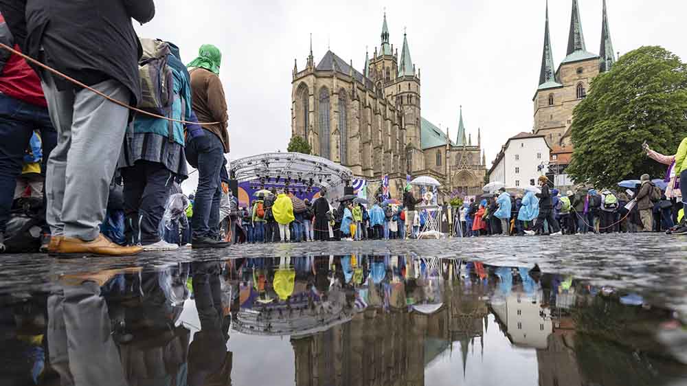 Regenjacken und Schirme sind beim Katholikentag sehr gefragt, auch beim Gottesdienst zu Fronleichnam