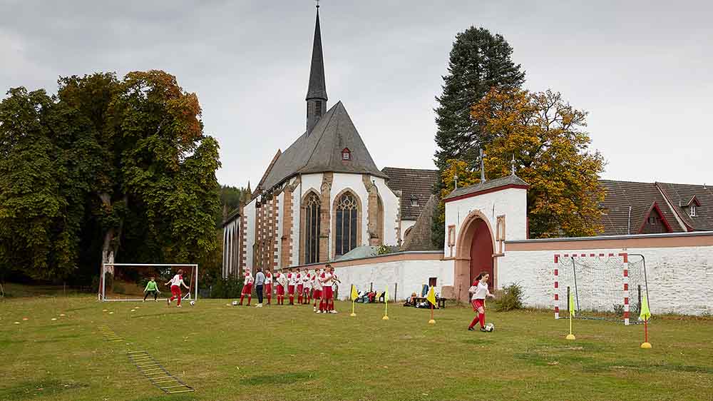 Vor dem Kloster trainiert die Fußball-Mannschaft