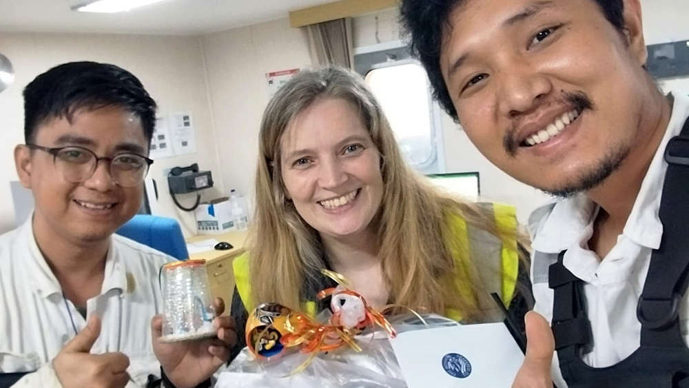 Andrea Meenken, Leiterin der Station Panama, übergibt am 05.12.2024 auf einem Schiff im Hafen von Panama bei einem Bordbesuch Weihnachtsgeschenke für die Crew