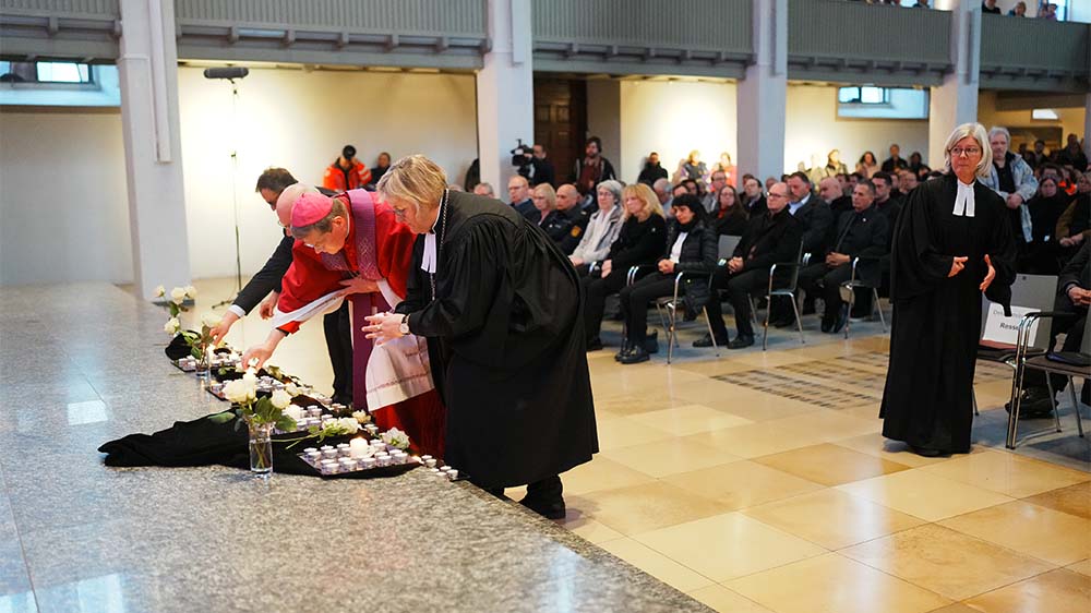 Die badische evangelische Landesbischöfin Heike Springhart und der Freiburger Erzbischof Stephan Burger zünden Kerzen an