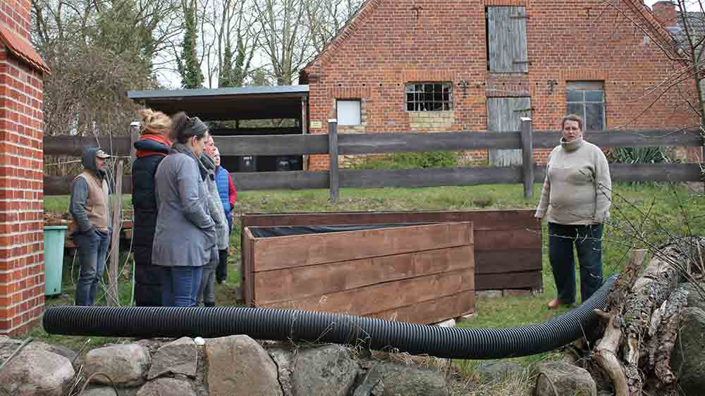 Maria Lachmann (re.) bespricht letzte Einzelheiten mit den Ehrenamtlichen, die den Klostergarten in Tempzin aufbauen.
