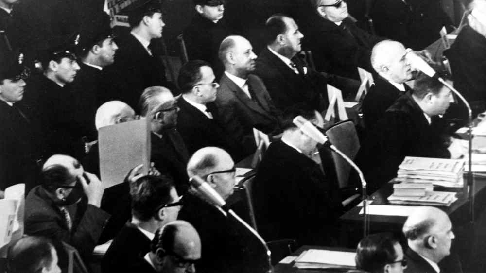 Acht der 22 Angeklagten im Auschwitz-Prozess sitzen zwischen ihren Verteidigern