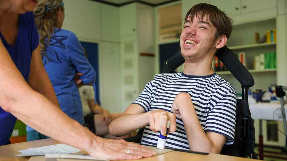 Ein Schueler der Stephen-Hawking-Schule in Neckargemuend klebt Karten mit Tipps fuer den Pilgerweg Camino Incluso